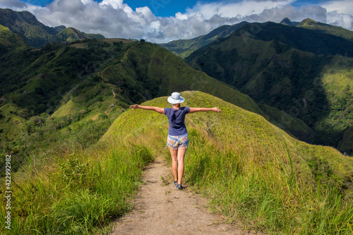 Tourist on the top of hill on natural mountain landscape. Tourist travels through the mountains. Photos of holidays in beautiful places. Tracker conquers mountain peaks. Outdoor activities.