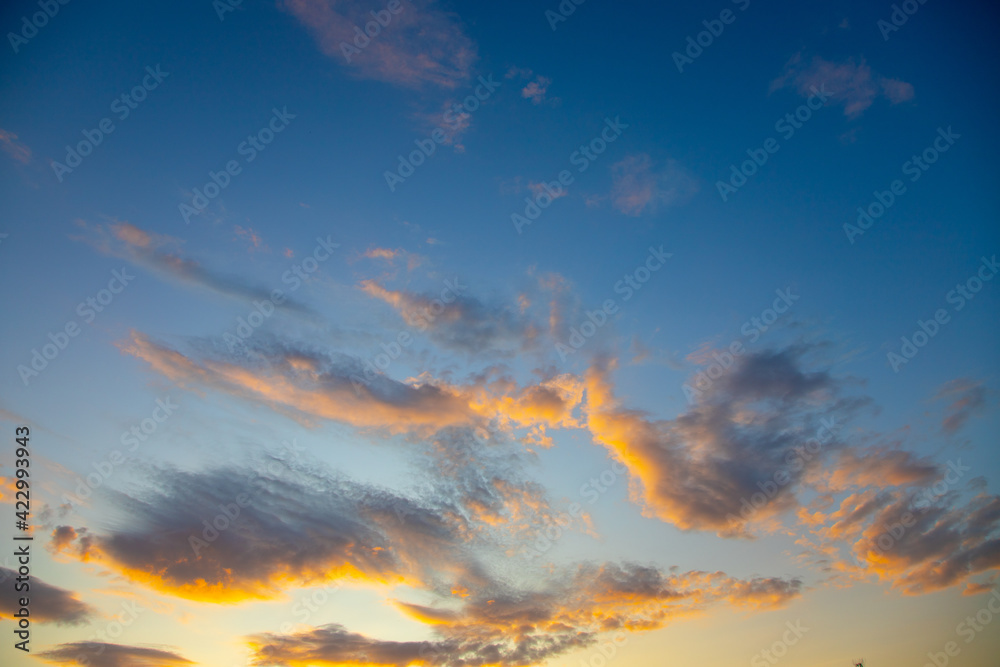 Sunset sky with pink yellow and orange clouds.