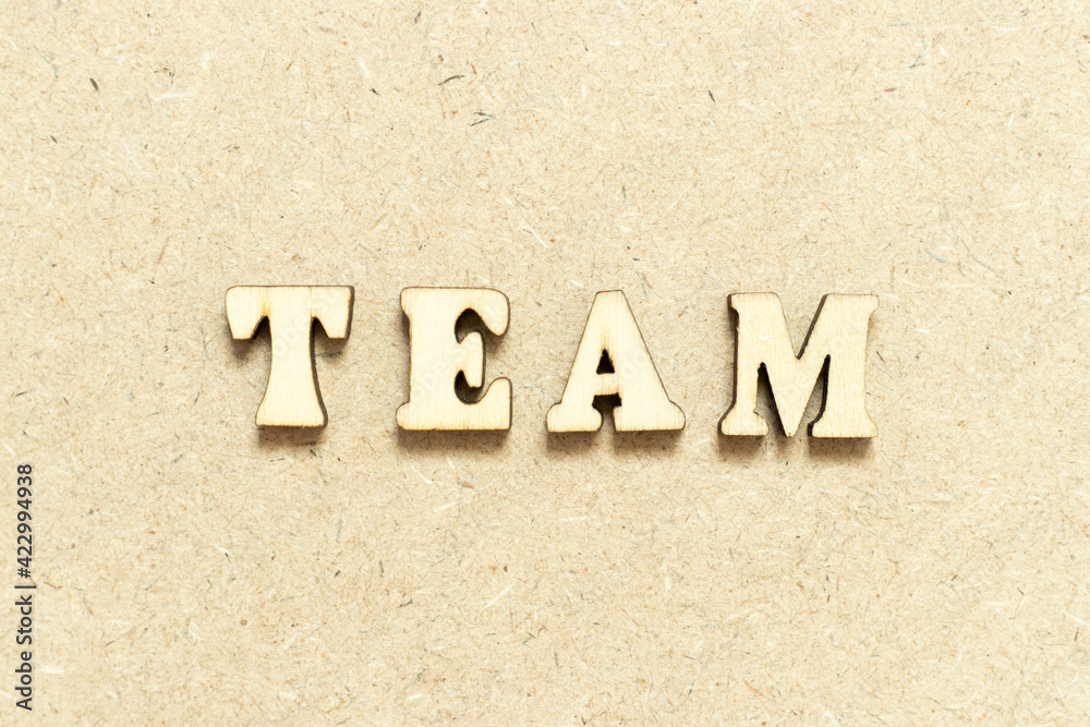 Alphabet letter in word team on wood background