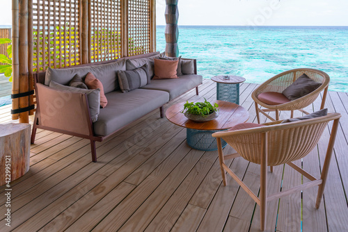 Luxurious exterior of a very expensive rich water villa in the Maldives, decorated with natural wood. photo