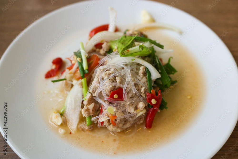 Spicy noodle vermicelli in white plate. Spicy grass noodle salad is Thai food. Food concept Spicy noodle vermicelli in white plate. Spicy grass noodle salad is Thai food. Food concept