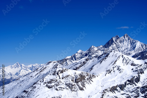 Snow capped mountains, snowfields and glaciers at Zermatt, Switzerland, seen from Gornergrat railway station. Photo taken March 23rd, 2021. © Michael Derrer Fuchs