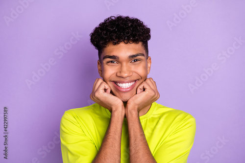 Photo of young cheerful african man happy positive smile hands touch chin isolated over violet color background