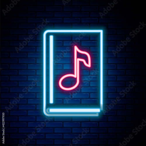 Glowing neon line Audio book icon isolated on brick wall background. Musical note with book. Audio guide sign. Online learning concept. Colorful outline concept. Vector