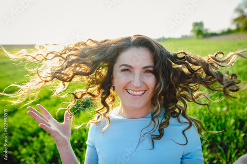 Принти на полотні Curly brunette enjoys sunshine in summer day
