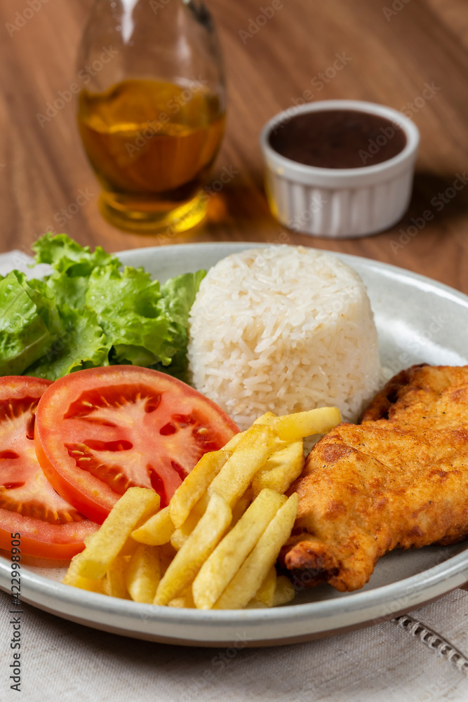 Executive dish with breaded fillet, rice, beans and salad. Executive dish with breaded fillet, rice, beans and salad.