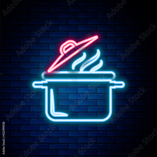 Glowing neon line Cooking pot icon isolated on brick wall background. Boil or stew food symbol. Colorful outline concept. Vector