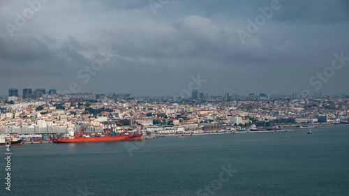 Cuadro en lienzo Gigantic ship stands at the pier of the Lisbon seaport and the view of the city