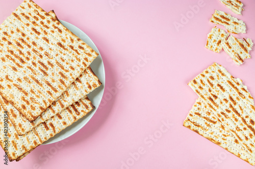 Matzo on a pink background. Traditional Jewish food.  for  regilious spring holiday of Pesach. Happy Passover. Copy space. photo