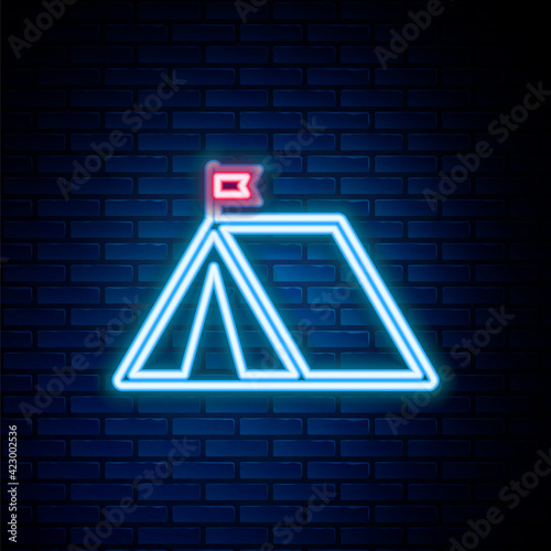 Glowing neon line Tourist tent with flag icon isolated on brick wall background. Camping symbol. Colorful outline concept. Vector