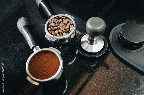 A portafilter with coffee beans, a portafilter with ground coffee