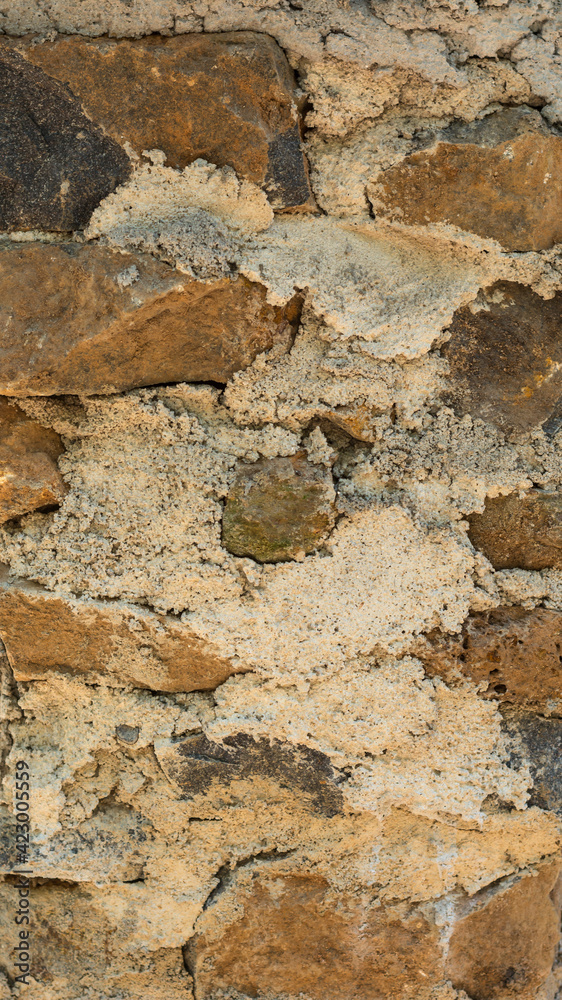 detail section of empty stone wall built with cement, closeup background texture