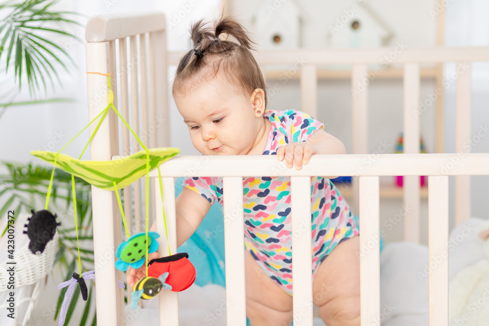 baby plays mobile in crib at home, early development baby plays mobile in crib at home, early development