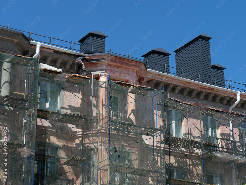 Scaffolding around a building, renovating facade building. Scaffolding around a building, renovating facade building.