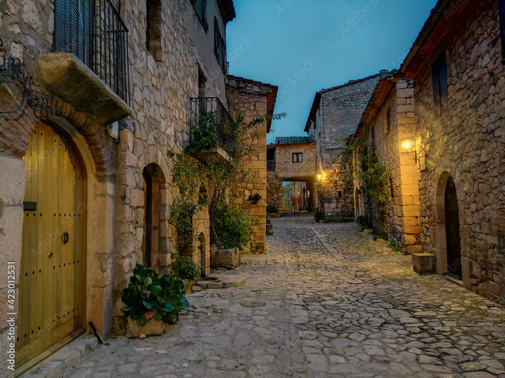 Fototapeta premium Street with stone houses of the beautiful town of Siurana at dusk, Province of Tarragona 