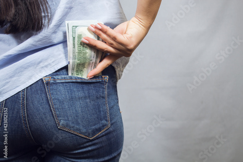 the girl puts money in her pocket
