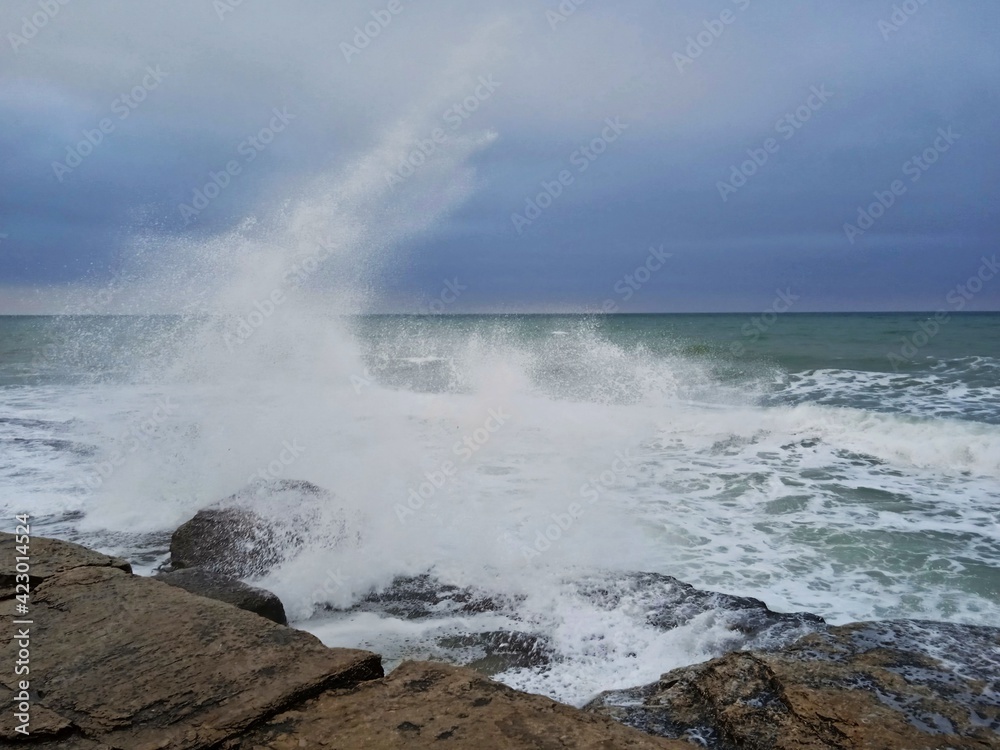 waves crashes into stone