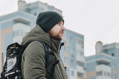 An epic photo of a man against the backdrop of high-rise buildings. Looking at the goal, choosing your own path.