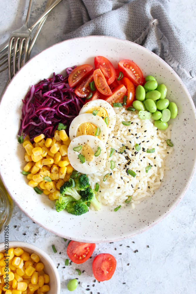 Rice salad with vegetables and sesame on light background. Top view with copy space. Healthy eating. Rice salad with vegetables and sesame on light background. Top view with copy space. Healthy eating.