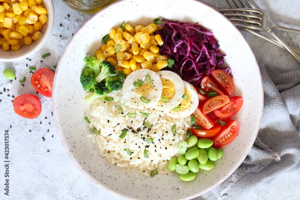 Rice salad with vegetables and sesame on light background. Top view with copy space. Healthy eating. Rice salad with vegetables and sesame on light background. Top view with copy space. Healthy eating.