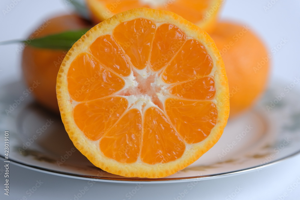 ripe and juicy tangerine (mandarin). cutaway tangerine fruit on a white background. ripe and juicy tangerine (mandarin). cutaway tangerine fruit on a white background.