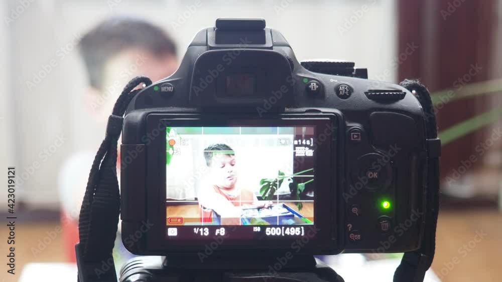 blogging, technology and people concept - happy smiling boy or blogger with camera recording video at home blogging, technology and people concept - happy smiling boy or blogger with camera recording video at home