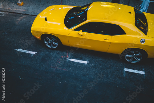 Yellow car parked on city street