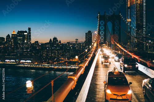 Illuminated New York skyline and traffic on Manhattan bridge © BullRun