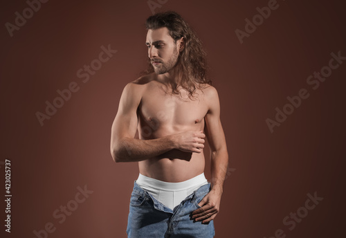 Sexy young man on dark colo...