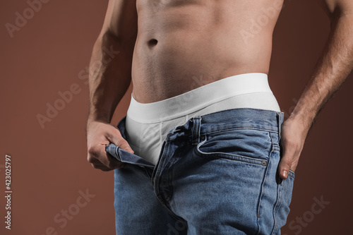 Sexy young man on dark colo...