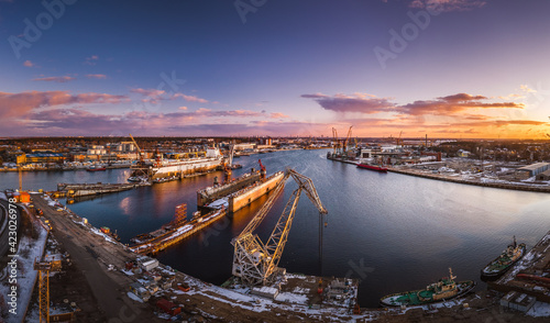 Ship repair and maintenance docks in beautiful sunset colors. Giant cargo vessel being repaired at dockyard in Riga. 