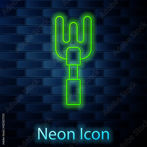 Glowing neon line Garden rake icon isolated on brick wall background. Tool for horticulture, agriculture, farming. Ground cultivator. Housekeeping equipment. Vector