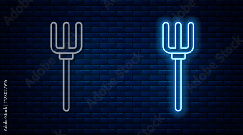 Glowing neon line Garden pitchfork icon isolated on brick wall background. Garden fork sign. Tool for horticulture, agriculture, farming. Vector
