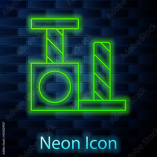 Glowing neon line Cat scratching post with toy icon isolated on brick wall background. Vector