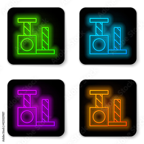 Glowing neon line Cat scratching post with toy icon isolated on white background. Black square button. Vector