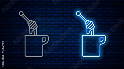 Glowing neon line Honey dipper stick with dripping honey icon isolated on brick wall background. Honey ladle. Vector