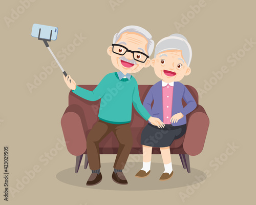 old couple take selfie on smartphone on sofa