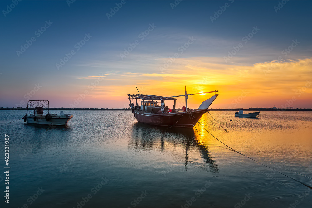 Boats on Dammam sea side with sunrise background view. Dammam, Saudi Arabia. Boats on Dammam sea side with sunrise background view. Dammam, Saudi Arabia.