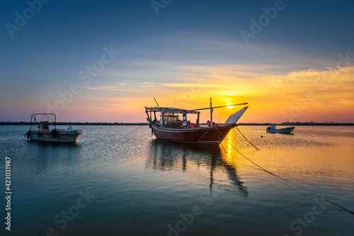 Boats on Dammam sea side with sunrise background view. Dammam, Saudi Arabia.