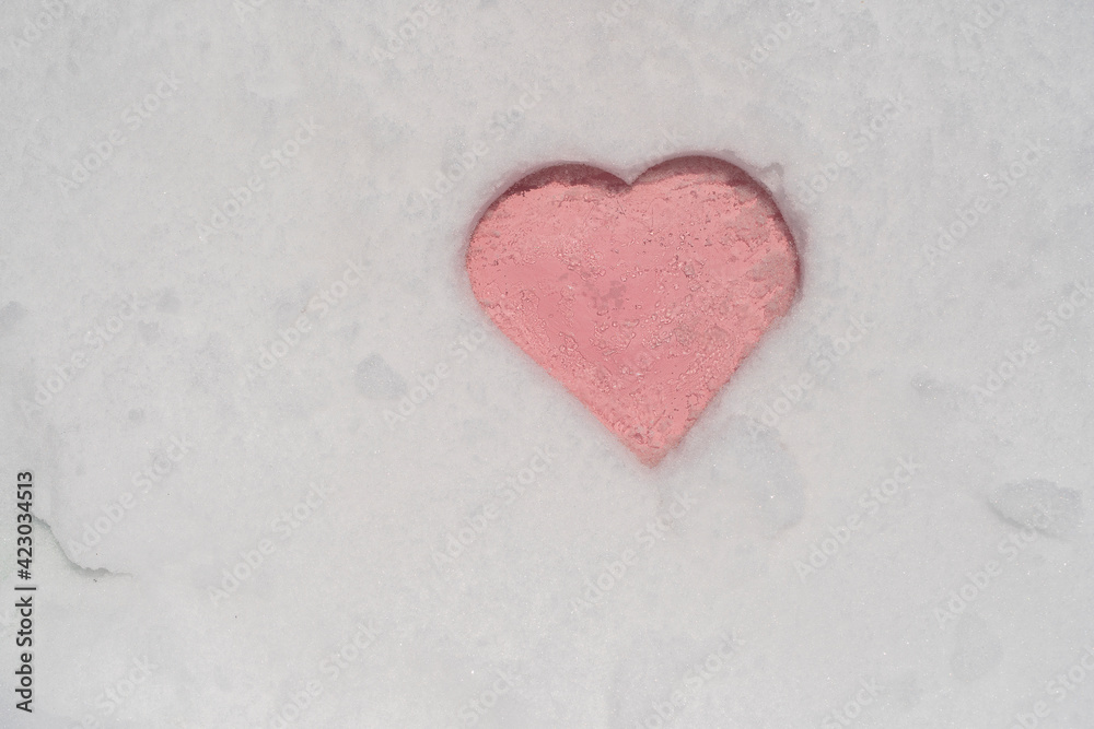 Pink heart shape on a white fresh snow in winter, close up Pink heart shape on a white fresh snow in winter, close up