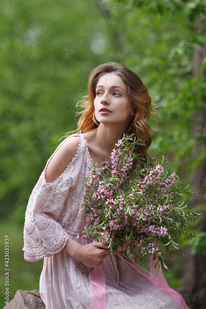 beautiful girl in a pink lace dress walks in the park with a bouquet of pink flowers, bride in boho style beautiful girl in a pink lace dress walks in the park with a bouquet of pink flowers, bride in boho style