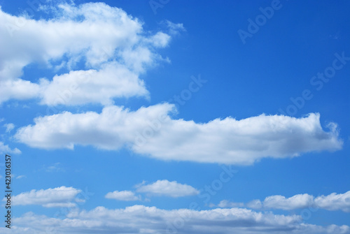 Afternoon white clouds and clear blue sky background. Peaceful sky in calm atmosphere. 