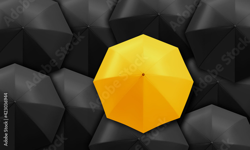Yellow umbrella standing out from background of black umbrellas. Business and leadership concept.