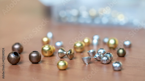 Fly knitting accessories. Brass and tungsten beads of different diameters.