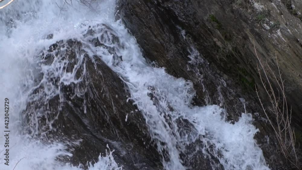 fast mountain stream with a waterfall closeup, slow motion fast mountain stream with a waterfall closeup, slow motion