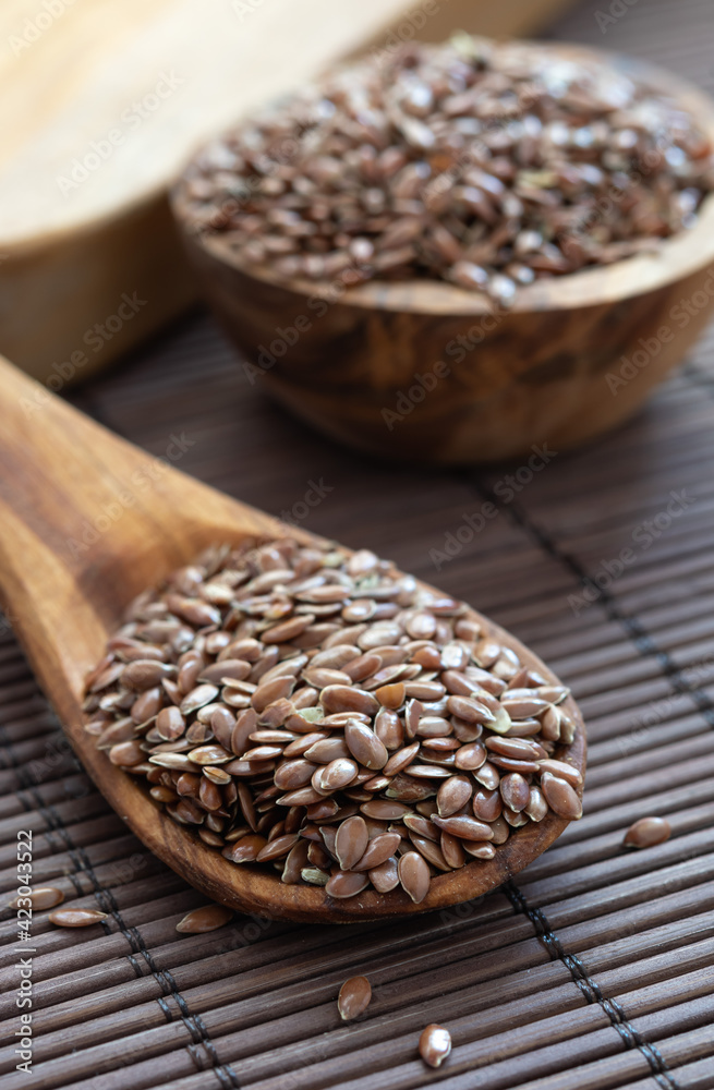 healthy nutrition product, flax seed on a spoon on a wooden table healthy nutrition product, flax seed on a spoon on a wooden table