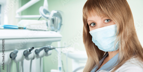 Female dentist in protective mask