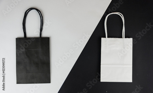The concept of love of shopping. Two color paper bags for shopping on a paper background. Flat lay. Top view.