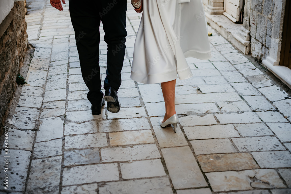 bride and groom walking wedding shoes