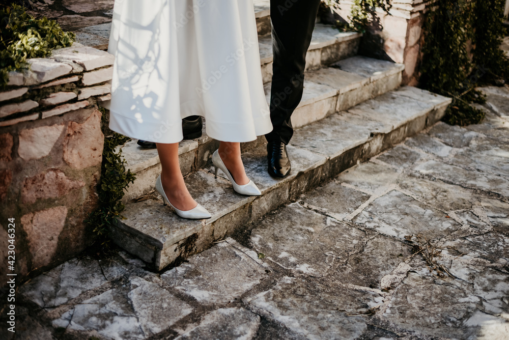 bride and groom walking wedding shoes